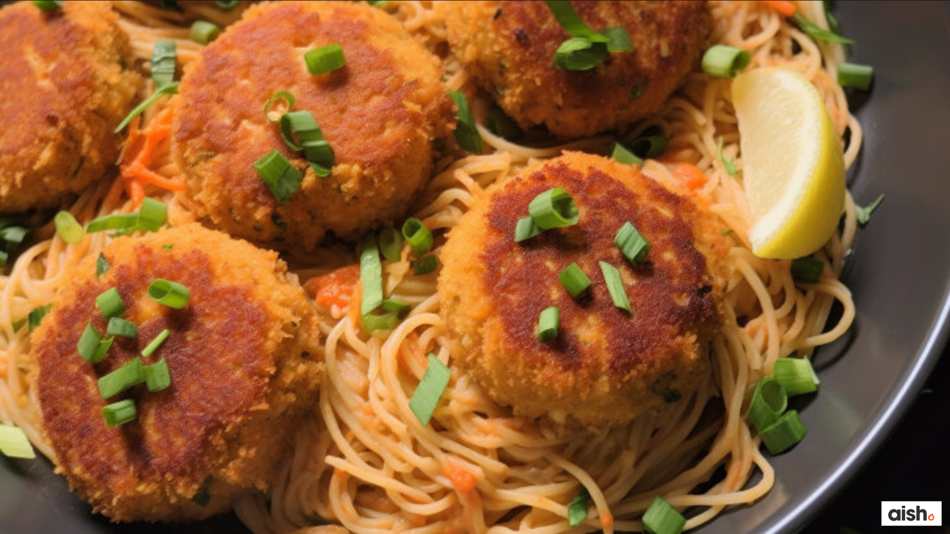 Jewish Spaghetti with Golden-Brown Patties, Scallions, and Lemon Golden-brown patties topped with chopped scallions on spaghetti beside a lemon wedge, with the Aish logo in the lower-right corner.